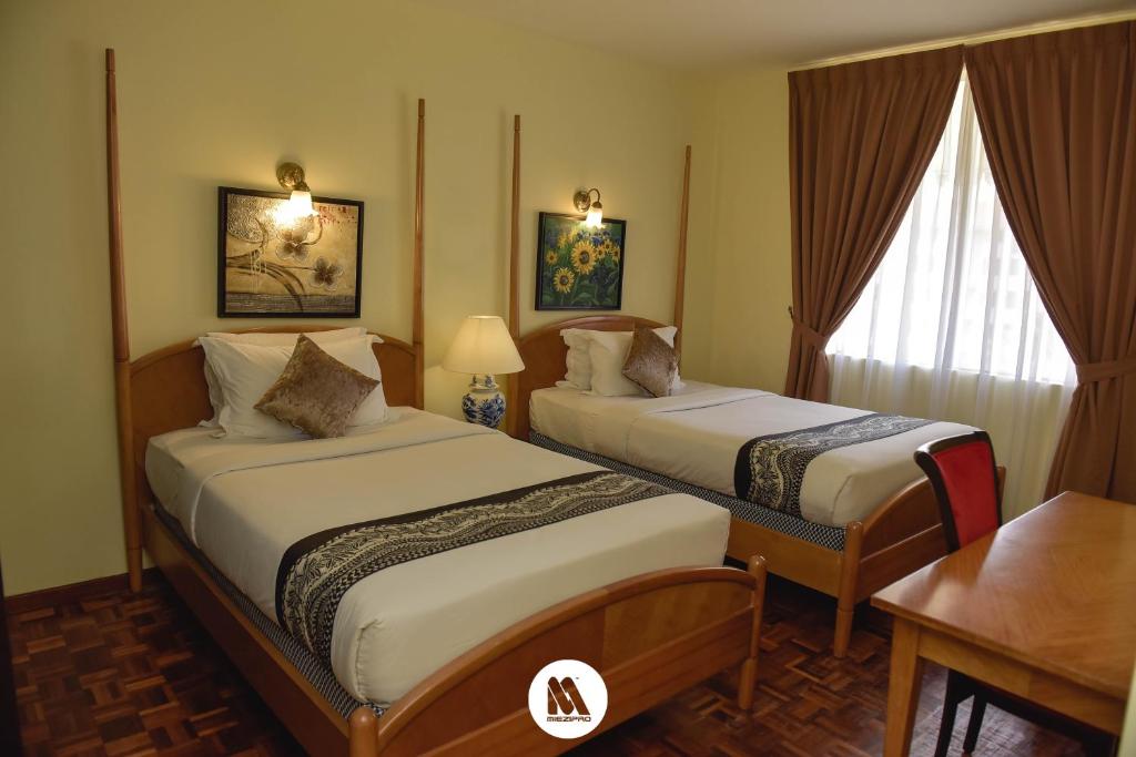 Postel nebo postele na pokoji v ubytování Lotus Desaru Beach Resort & Spa