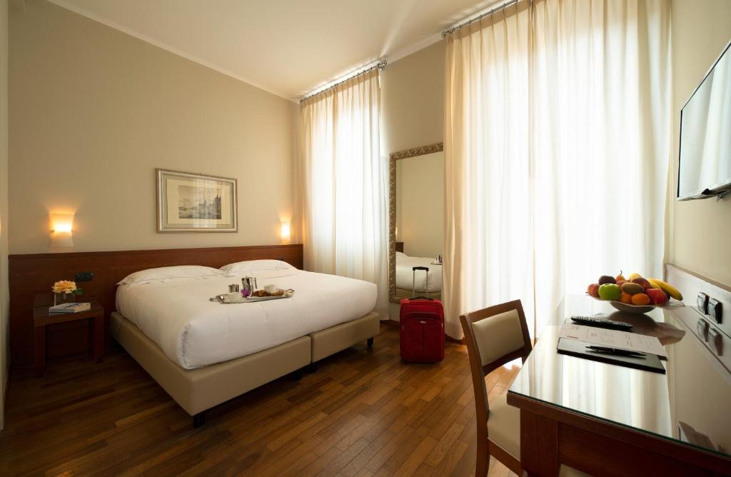 Postel nebo postele na pokoji v ubytování Hotel Fenice