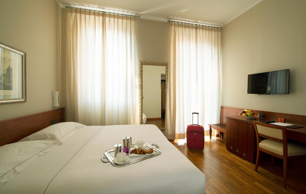 Postel nebo postele na pokoji v ubytování Hotel Fenice