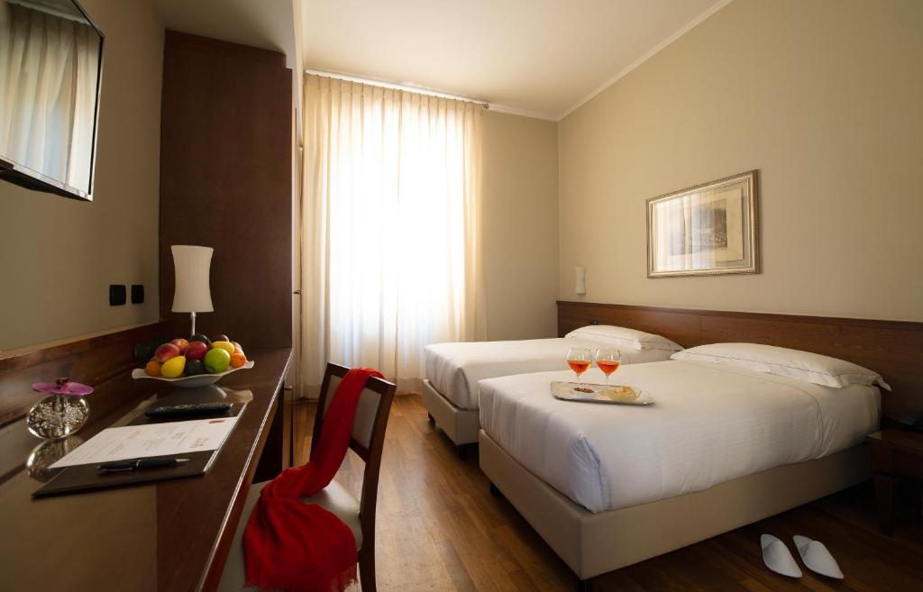 Postel nebo postele na pokoji v ubytování Hotel Fenice
