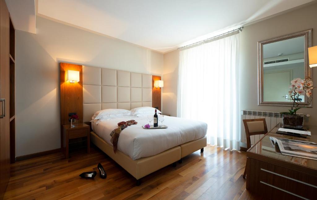 Postel nebo postele na pokoji v ubytování Hotel Fenice
