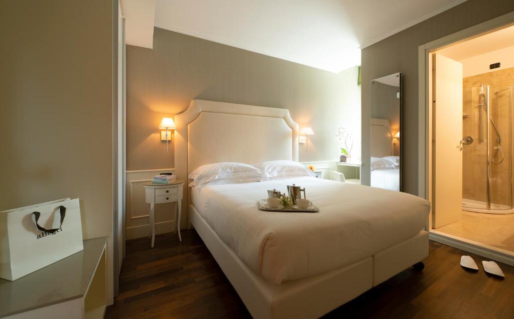 Postel nebo postele na pokoji v ubytování Hotel Fenice