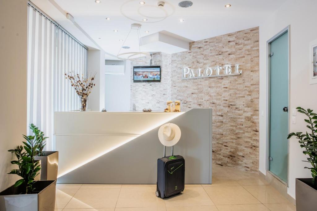 a lobby of an office with a reception desk at Palotel Design Gouvia in Gouvia