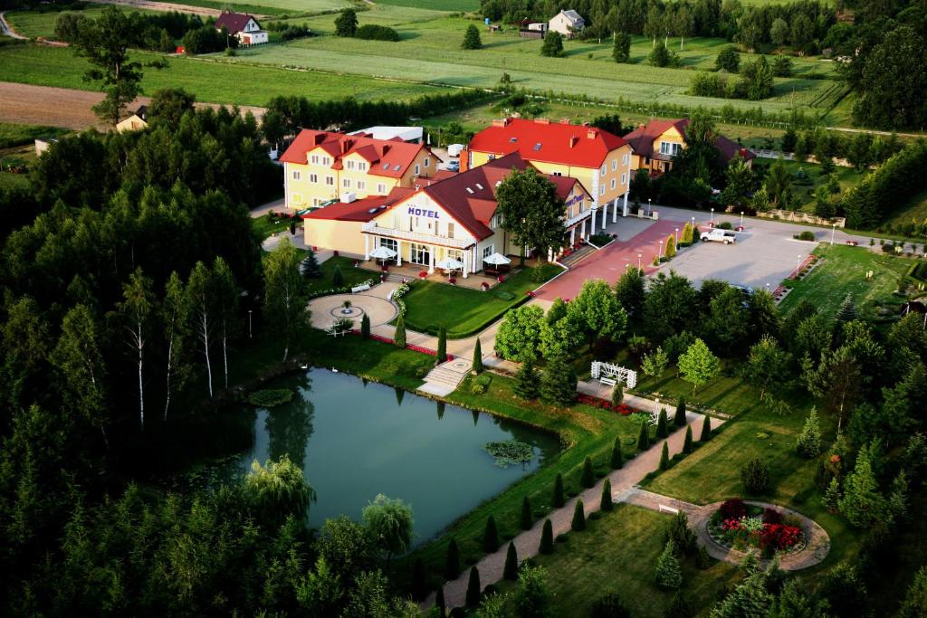 an aerial view of a house and a lake at Hotel Chabrowy Dworek in Teresin