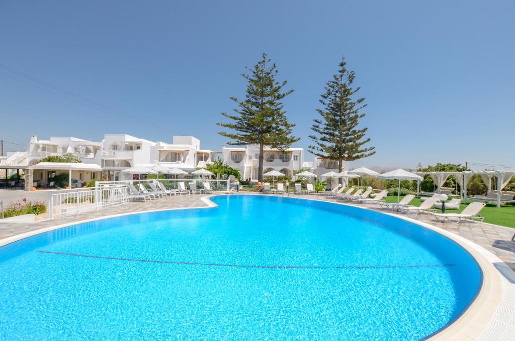 a large swimming pool in front of a resort at Birikos Hotel & Suites in Agios Prokopios