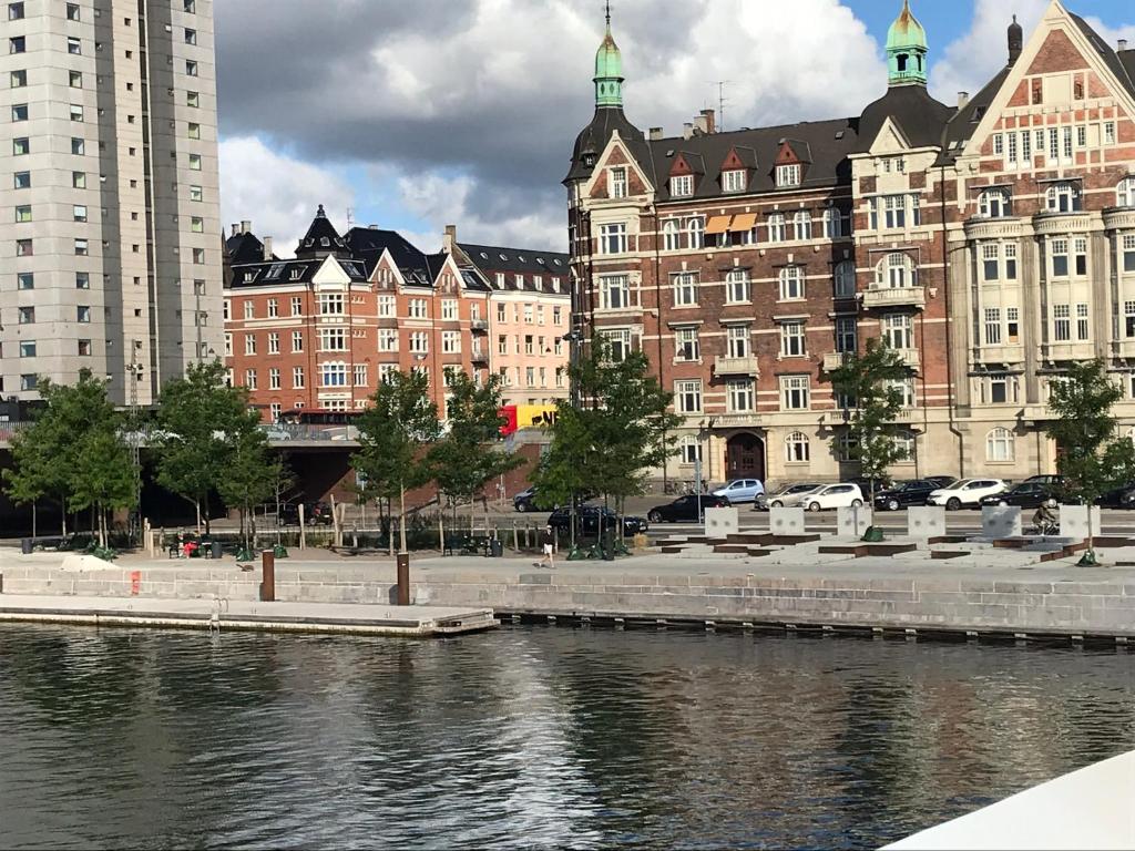 哥本哈根的住宿－Guest rooms harbor view，一群靠近水体的建筑物