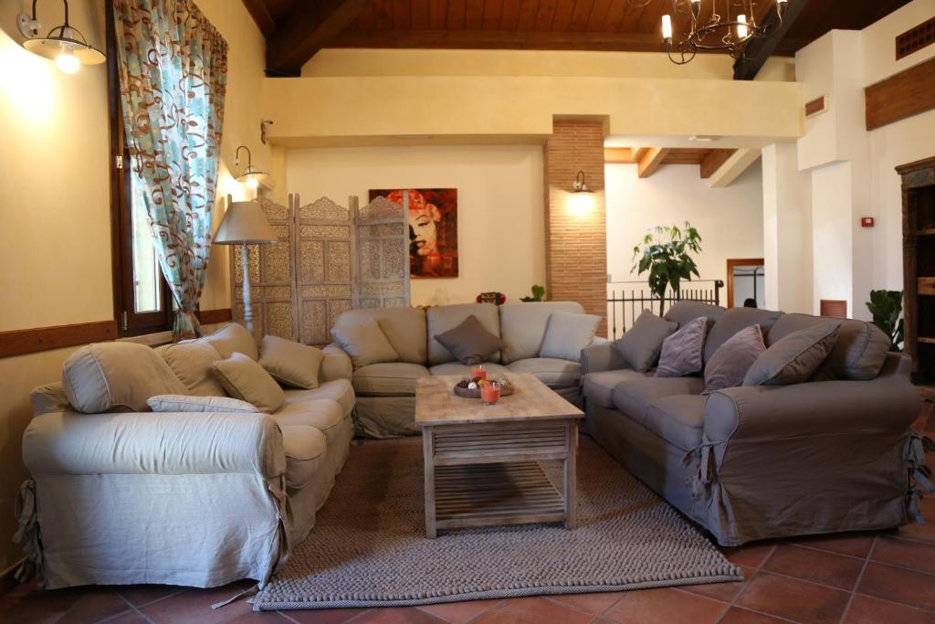 a living room with couches and a table at La Puraza Comfort Rooms in Rimini