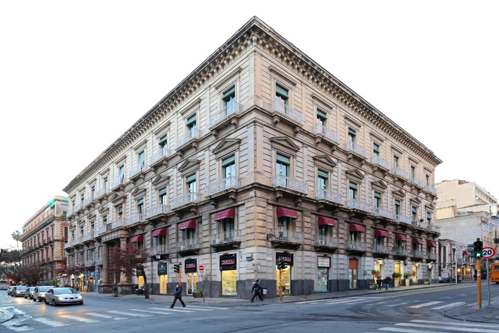 a large building on the corner of a street at Catania Centro Rooms in Catania
