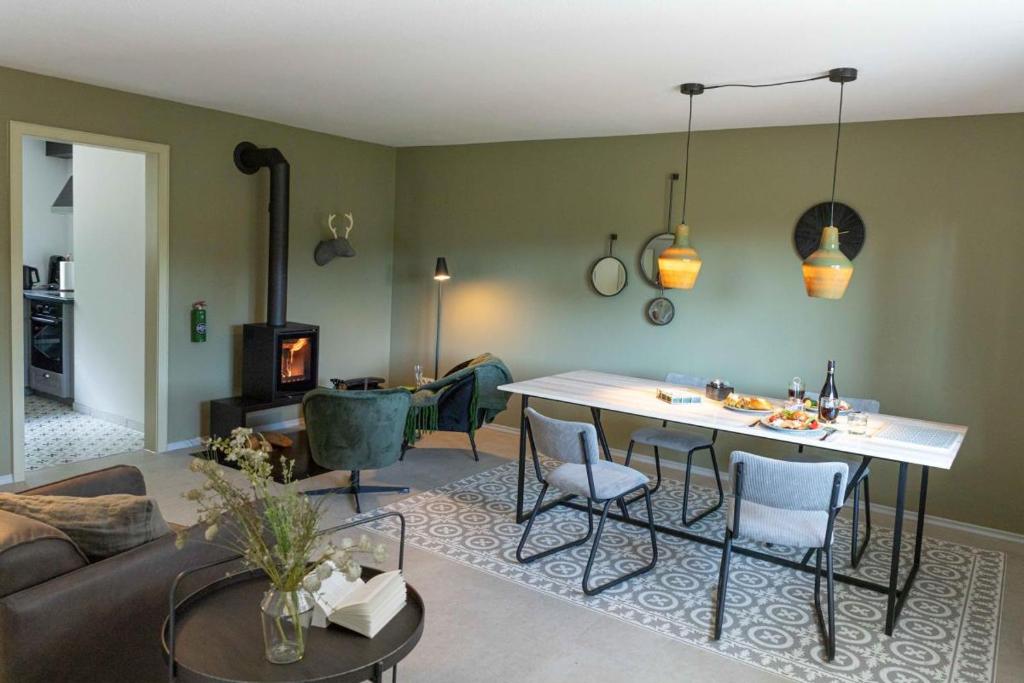 a living room with a table and chairs and a couch at Haus Grün in Niederstetten