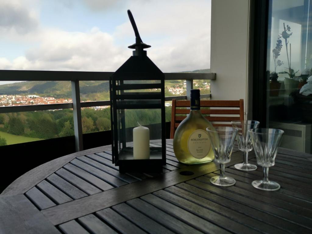 a bottle of wine sitting on a table with glasses at Apartment Harzblick in Bad Lauterberg