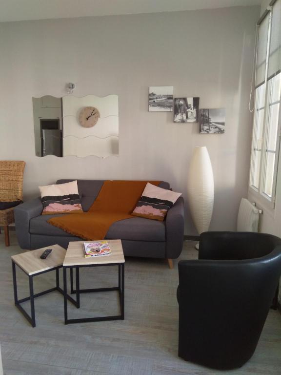 un salon avec un canapé et une table dans l'établissement Nid Douillet, à Rochefort