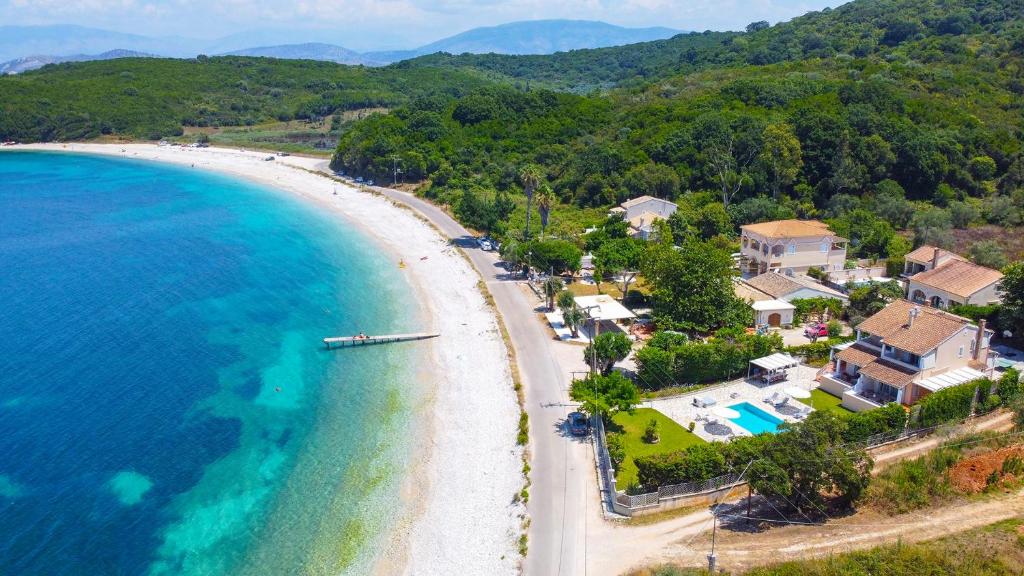 an aerial view of a beach with houses and the ocean at Avlaki Beachfront Villa in Kassiopi