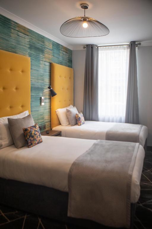 Postel nebo postele na pokoji v ubytování Paddington Park Hotel
