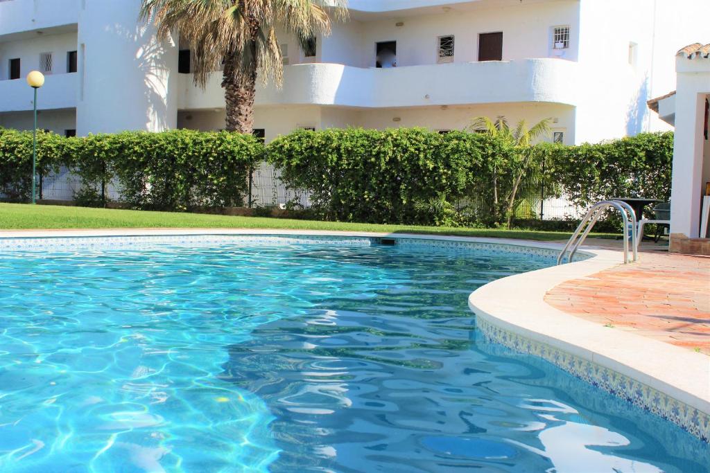 a swimming pool in front of a building at Sunny Vilamoura Pool Apartment- Free Parking- Fiber Wi-Fi in Vilamoura