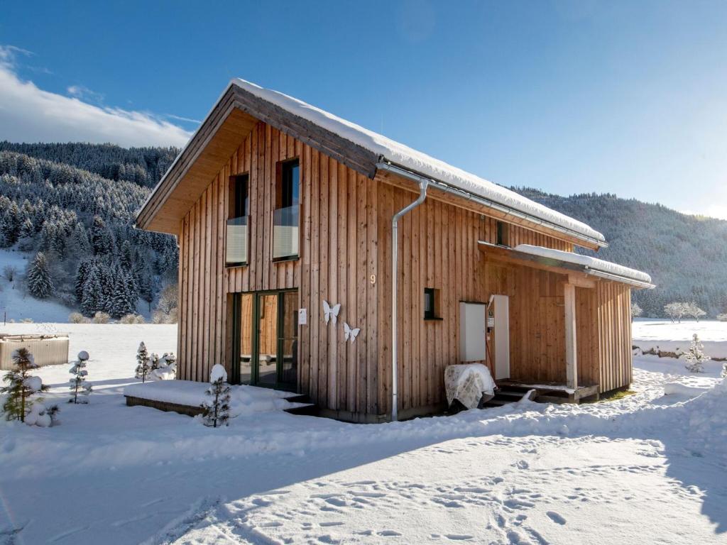 a small wooden building in the snow with snow at Chalet Sonnenblick in Laßrchberg