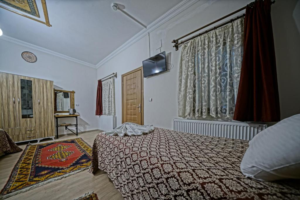 Postel nebo postele na pokoji v ubytování Göreme Art Stone