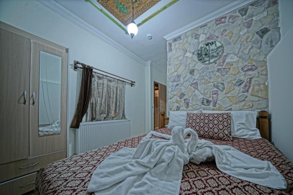 Postel nebo postele na pokoji v ubytování Göreme Art Stone