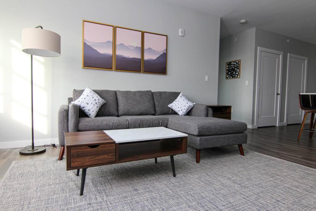 a living room with a couch and a coffee table at Luxury apartment with gym, steps from commuter rail #4011 in Reading