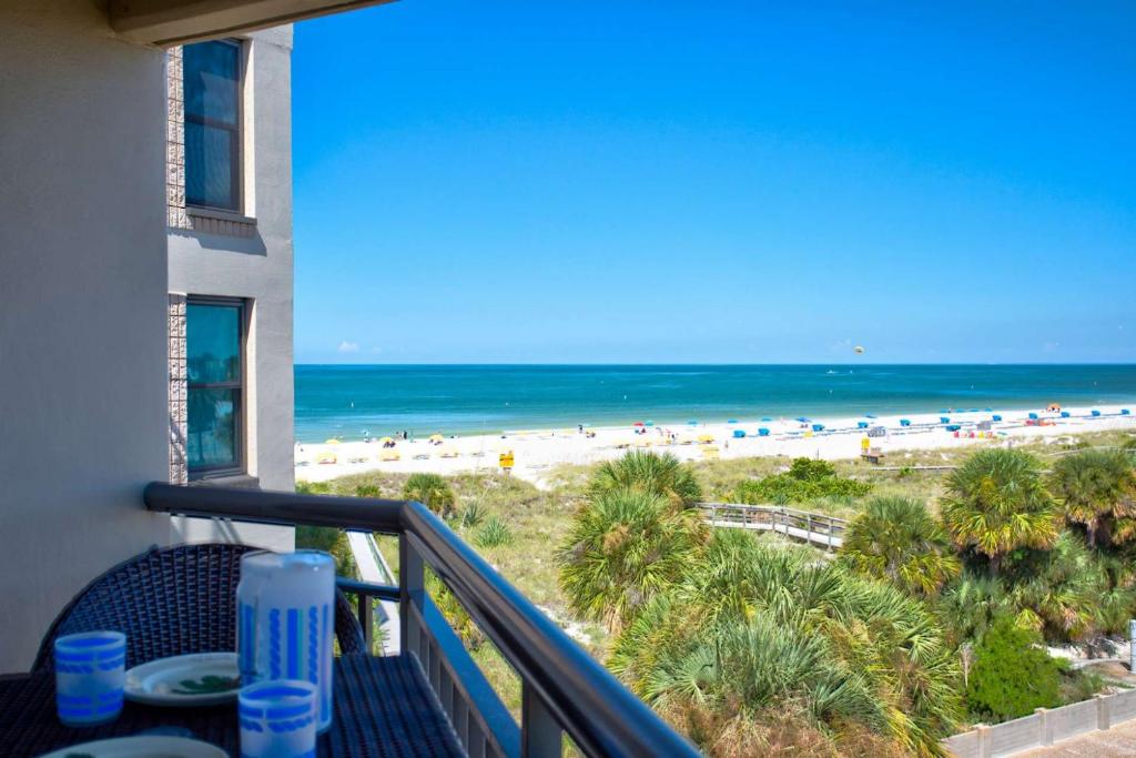 a balcony with a view of the beach at 505 - Gulf Strand in St. Pete Beach
