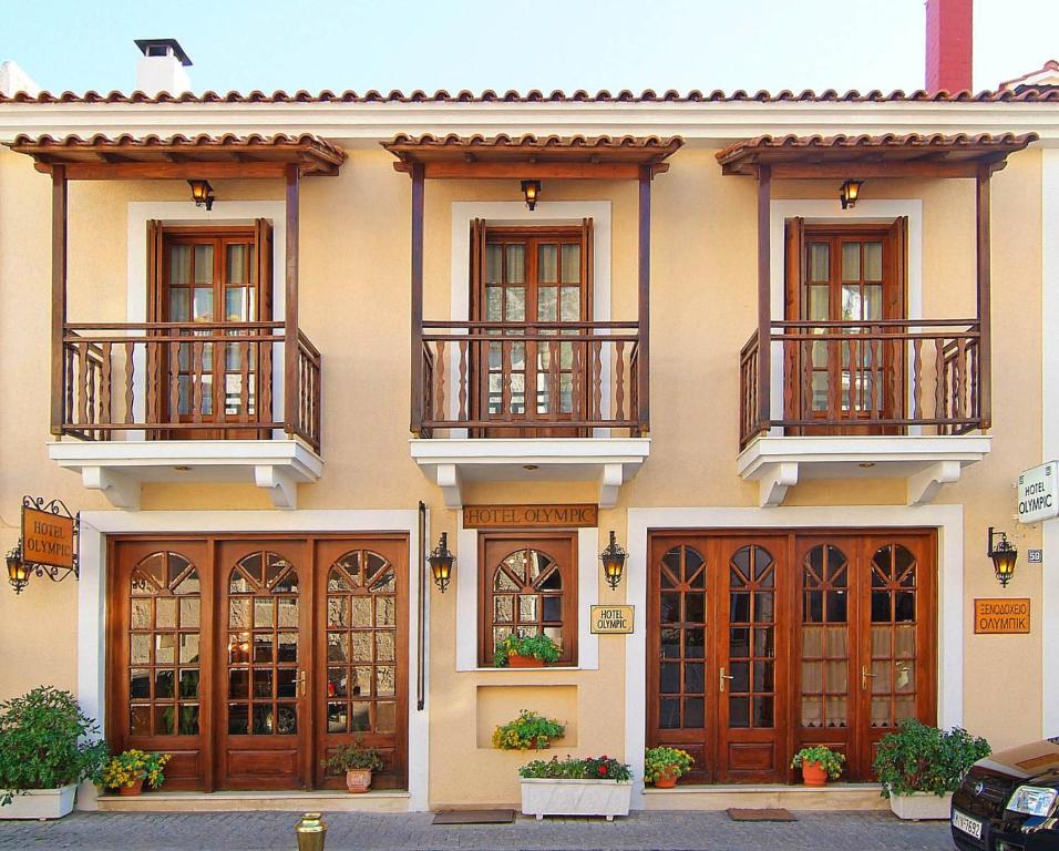 a building with a bunch of doors and windows at Olympic Hotel in Delphi