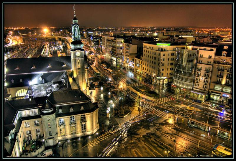 a view of a city at night with a clock tower at Cozy Studio Apart - King Bed - Netflix - Projector - Fast Wi-Fi in Luxembourg