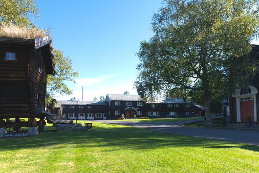 a large building with a tree in the middle of a yard at Lysebu Hotel in Oslo