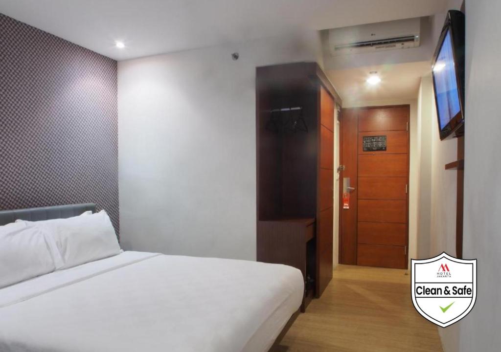 Postel nebo postele na pokoji v ubytování M Hotel