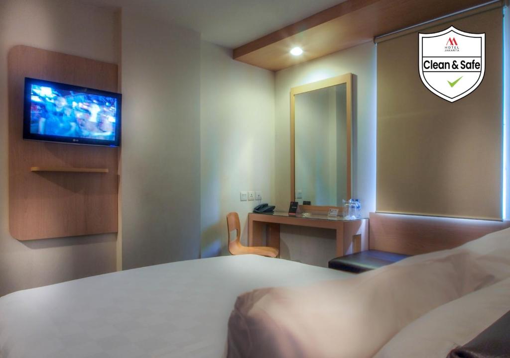 Postel nebo postele na pokoji v ubytování M Hotel