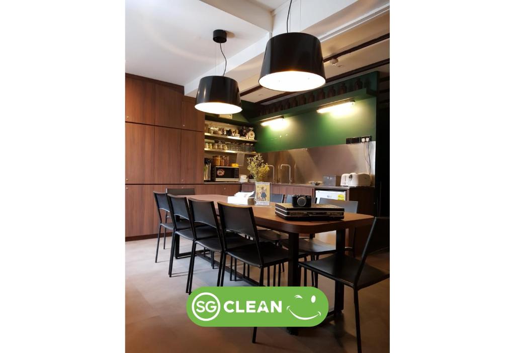 a kitchen and dining room with a table and chairs at Wink at Mosque Street in Singapore
