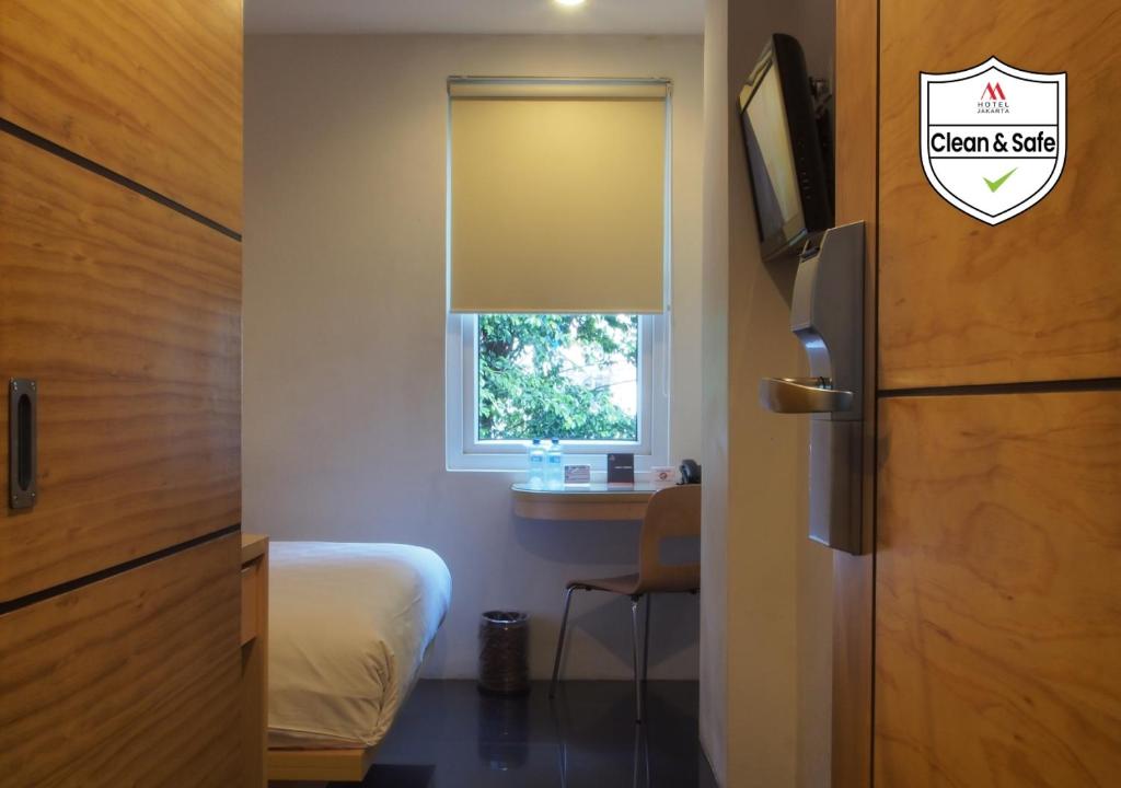 Postel nebo postele na pokoji v ubytování M Hotel