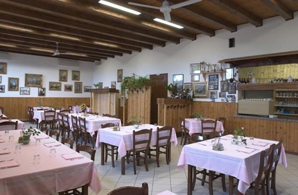 una sala da pranzo con tavoli e sedie con tovaglia rosa di Agriturismo la Chioccia a Campagna Lupia