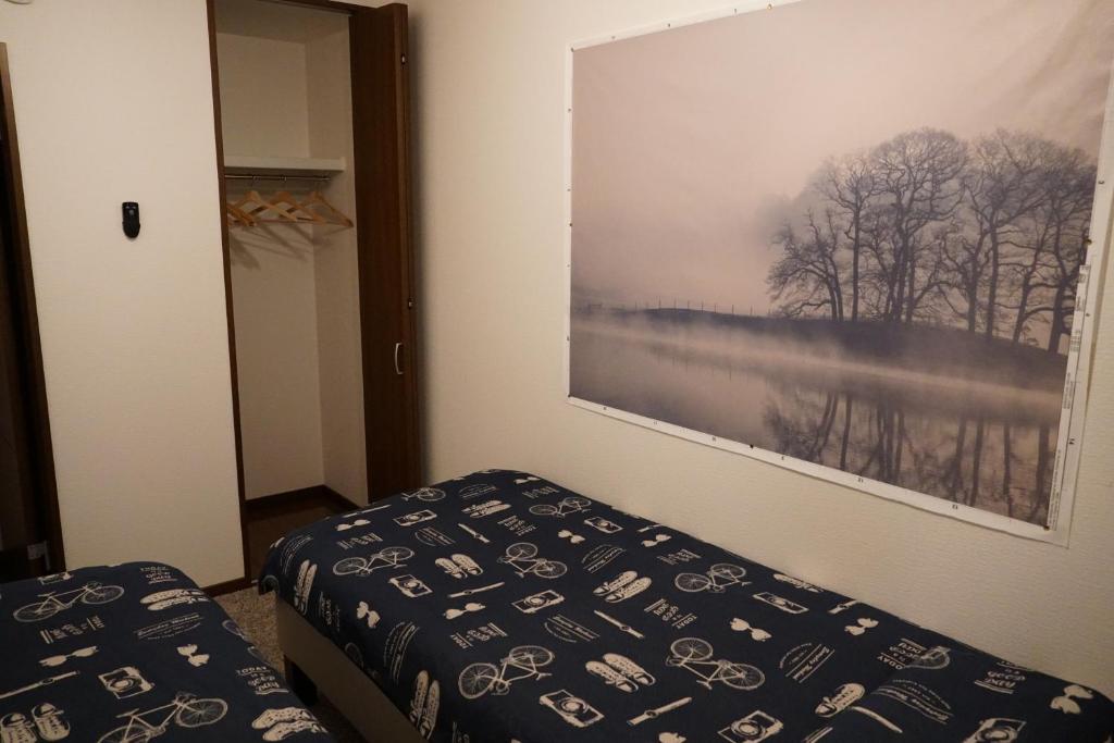 Postel nebo postele na pokoji v ubytování Auberge du Tanuki Noir Maison d'Hôtes