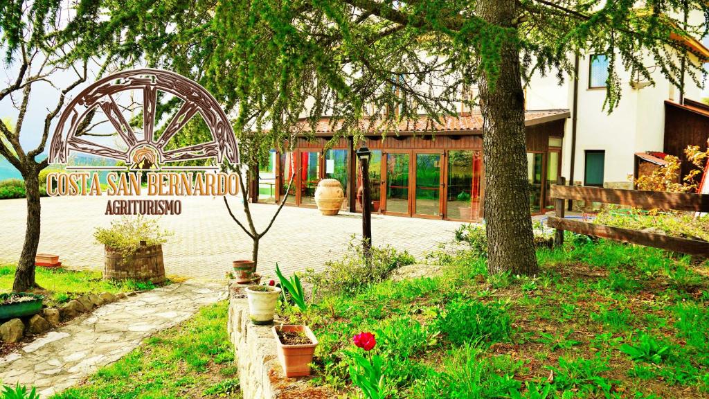 a sign in a garden in front of a building at Agriturismo Costa San Bernardo in Vaglio di Basilicata