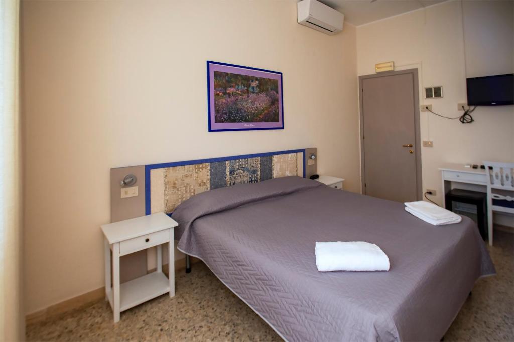 Postel nebo postele na pokoji v ubytování Hotel Sabatino