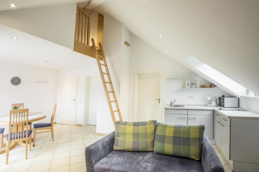 a living room with a couch and a ladder at Haus Ambros in Bettingen