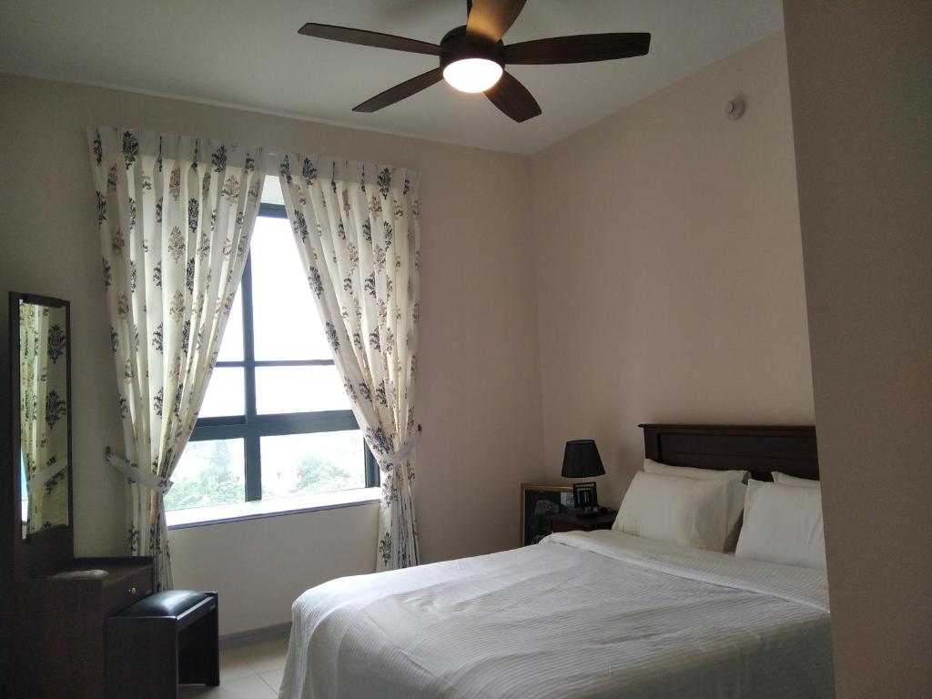 a bedroom with a bed with a ceiling fan and a window at Stratford Serenade Havelock City Luxury Apartment in Havelock Town