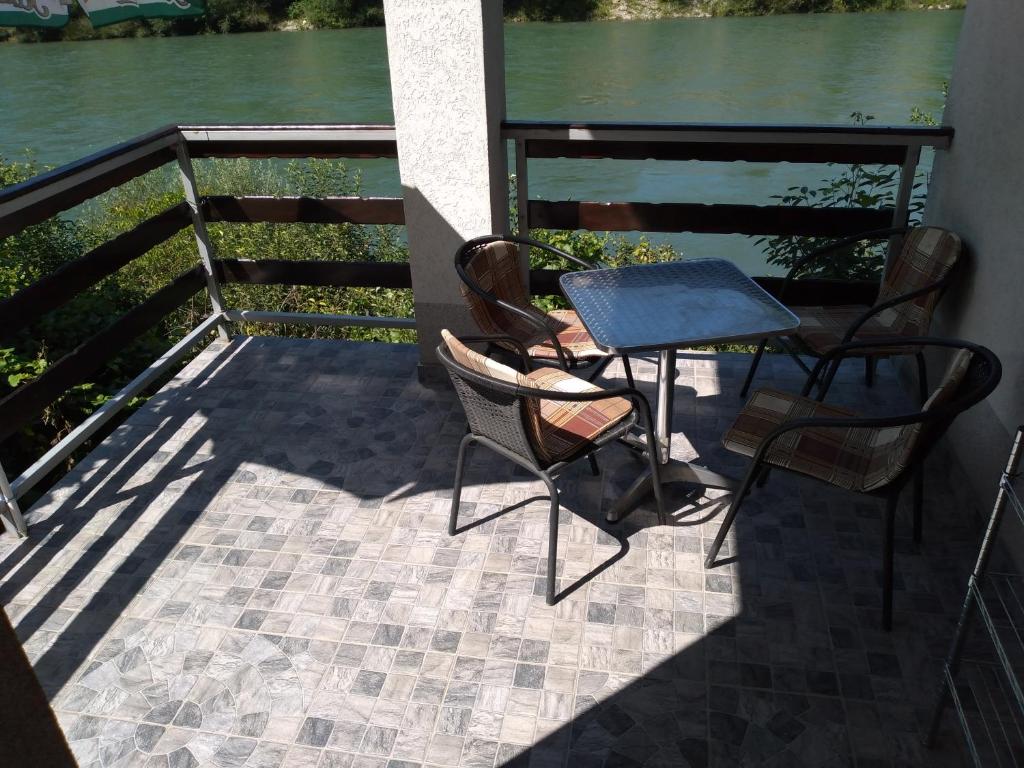a patio with chairs and a table on a balcony at Vikendica pored Drine Foča in Handići