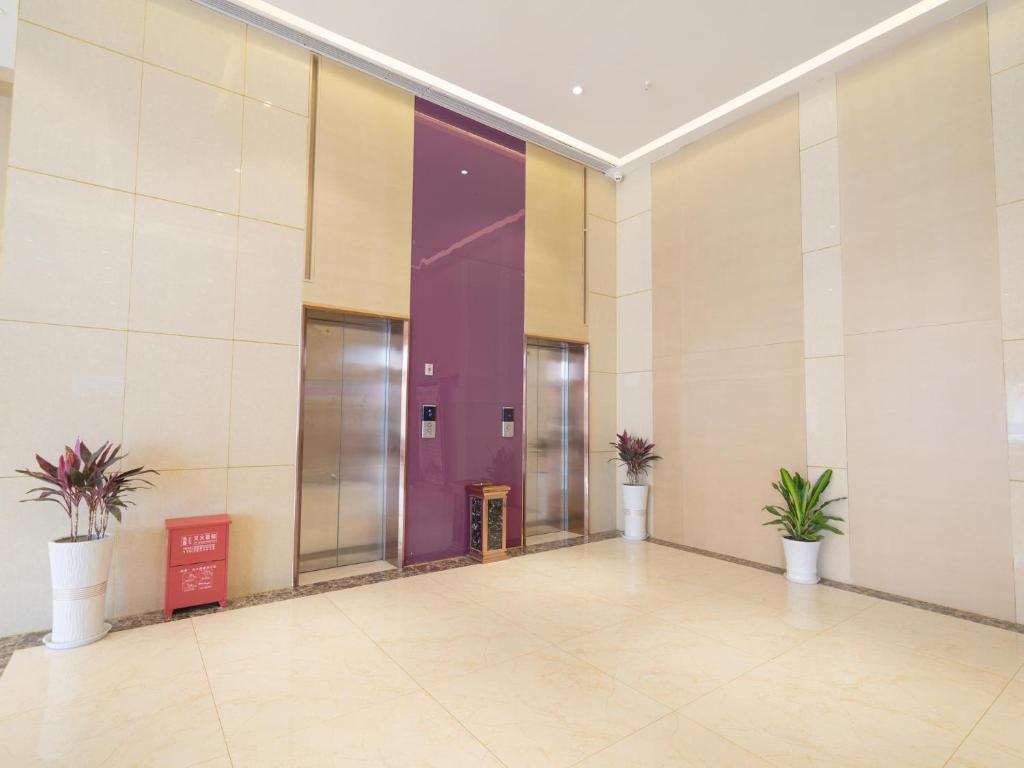 an empty hallway with potted plants in a building at Lavande Hotel(Macheng High-speed Station Branch) in Macheng