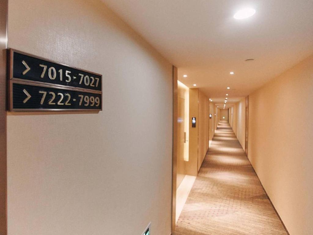 a hotel hallway with a sign on the wall at Lavande Hotel Ningbo Railway Station North Square in Ningbo