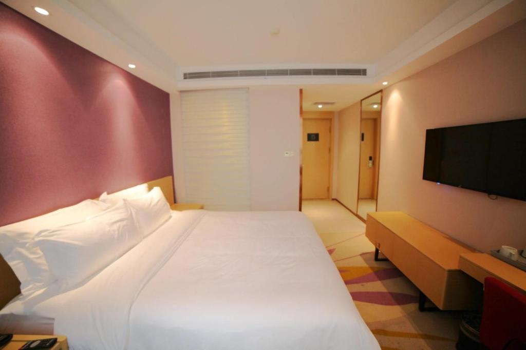 Tempat tidur dalam kamar di Lavande Hotel (Harbin Ice and Snow World University of Commerce Branch)