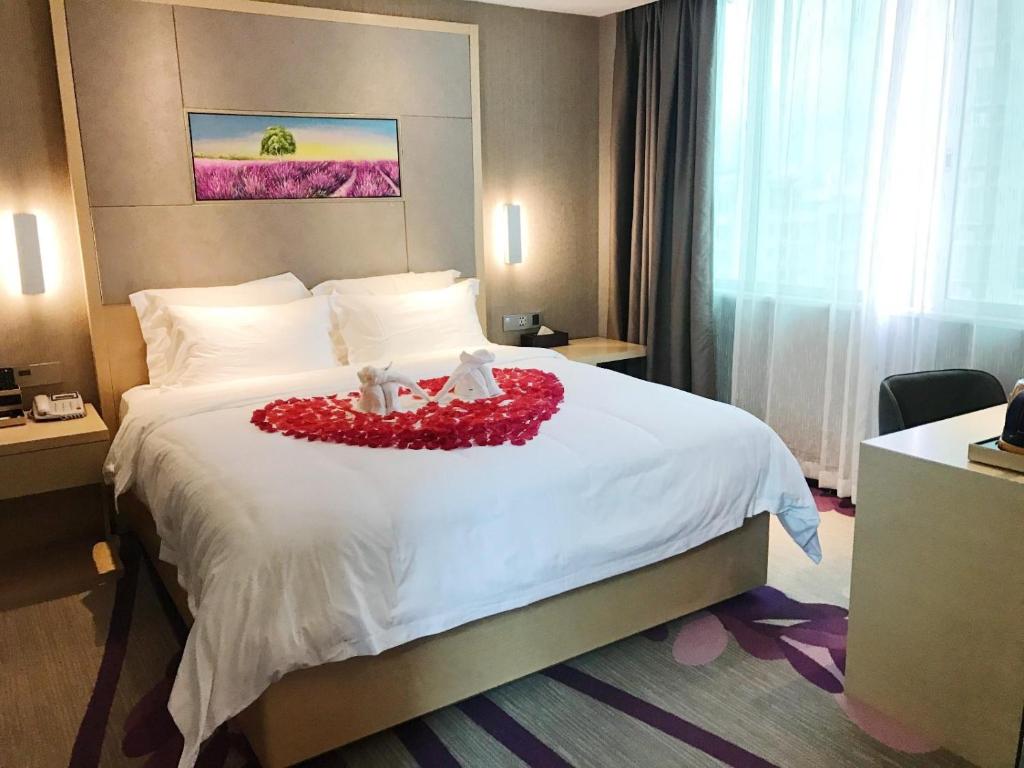 Llit o llits en una habitació de Lavande Hotel (Xinyi Fuhai Building Branch)