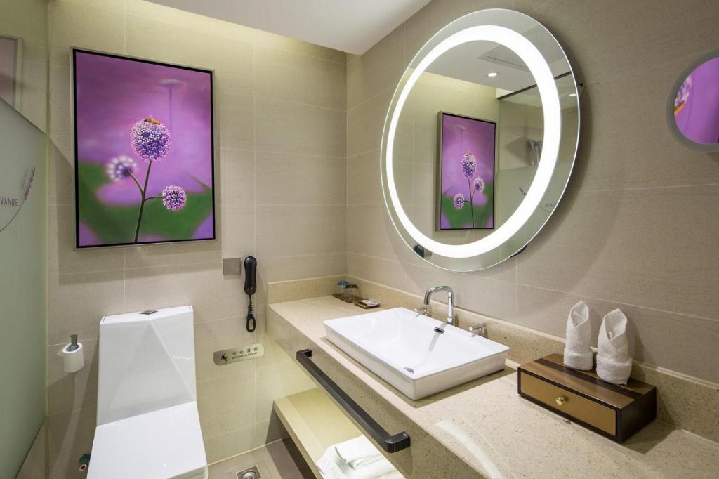 a bathroom with a sink and a mirror at Lavande Hotel Changsha High-speed Railway Station Shuling in Changsha