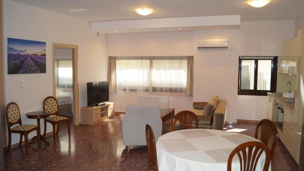 a living room with a table and chairs and a kitchen at Luxury Apartment in Plaka - Acropolis (Lavender) in Athens