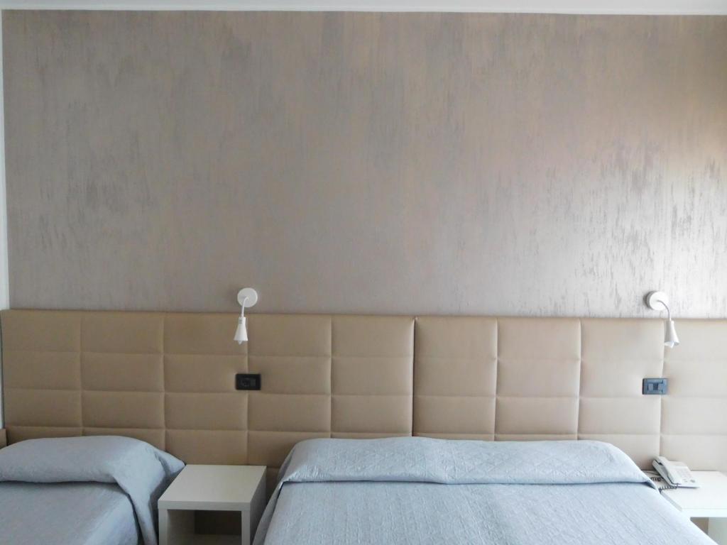 Postel nebo postele na pokoji v ubytování Hotel Emperador