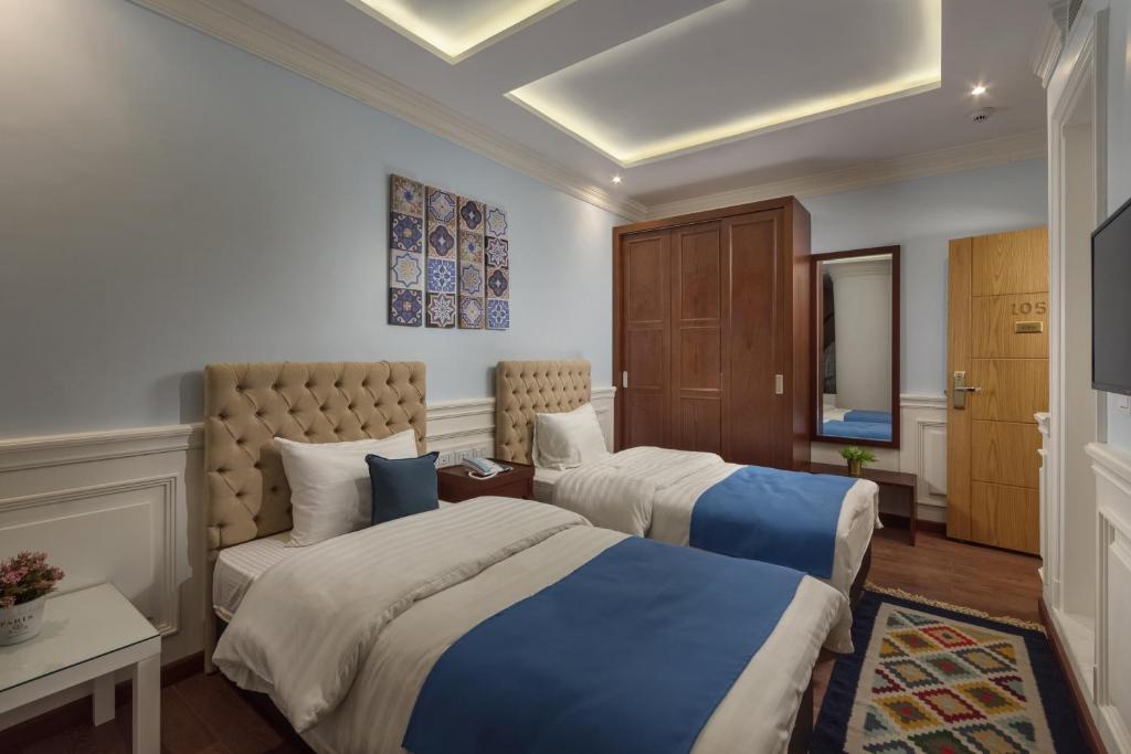 Postel nebo postele na pokoji v ubytování Miramar Boutique Hotel