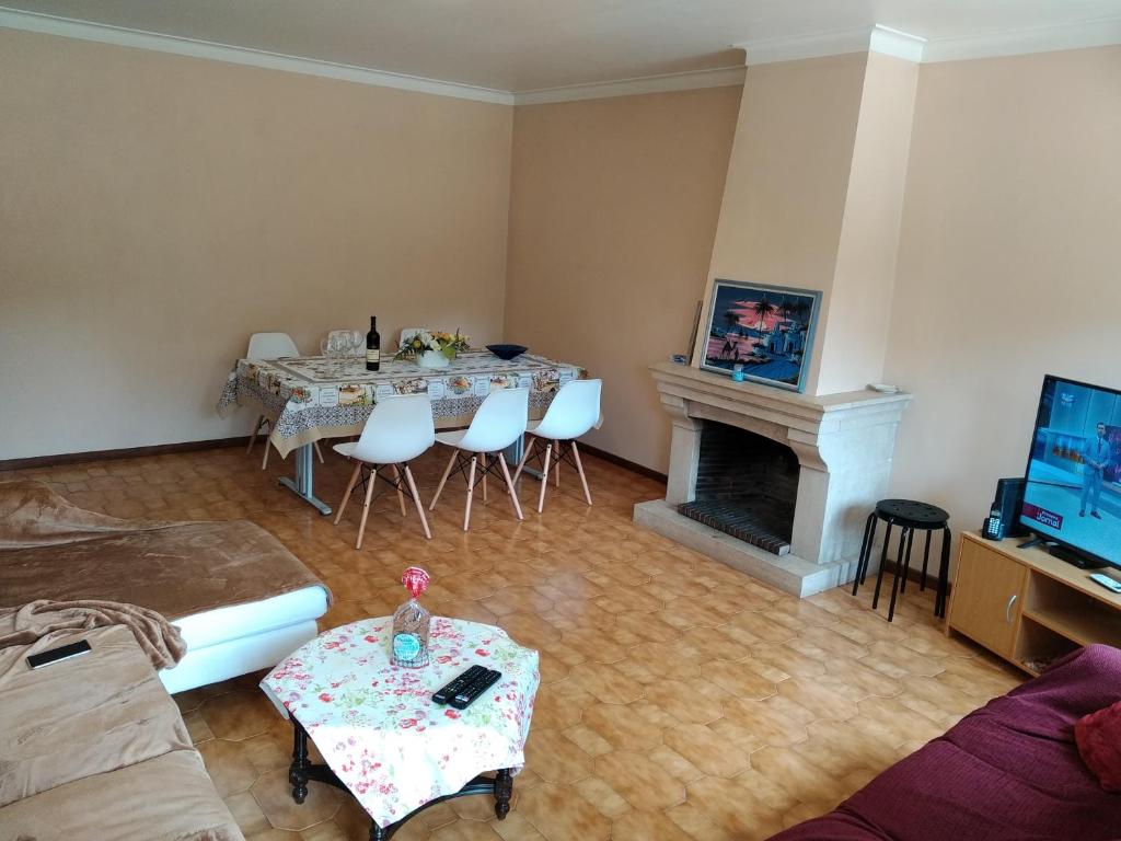 a living room with a table and a fireplace at Apartamento Solvita in Coimbra