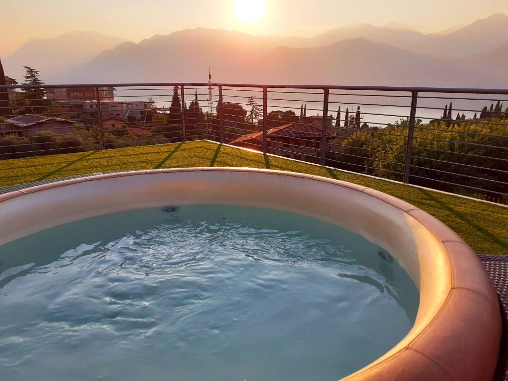 a hot tub with a view of the mountains at Park Hotel Val Di Monte ***S in Malcesine