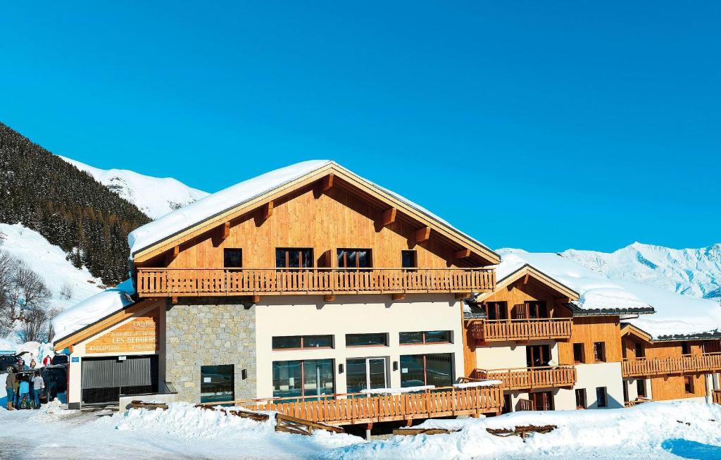 a large building with snow on the roof at travelski home select - Résidence Les Bergers in Saint-Sorlin-dʼArves
