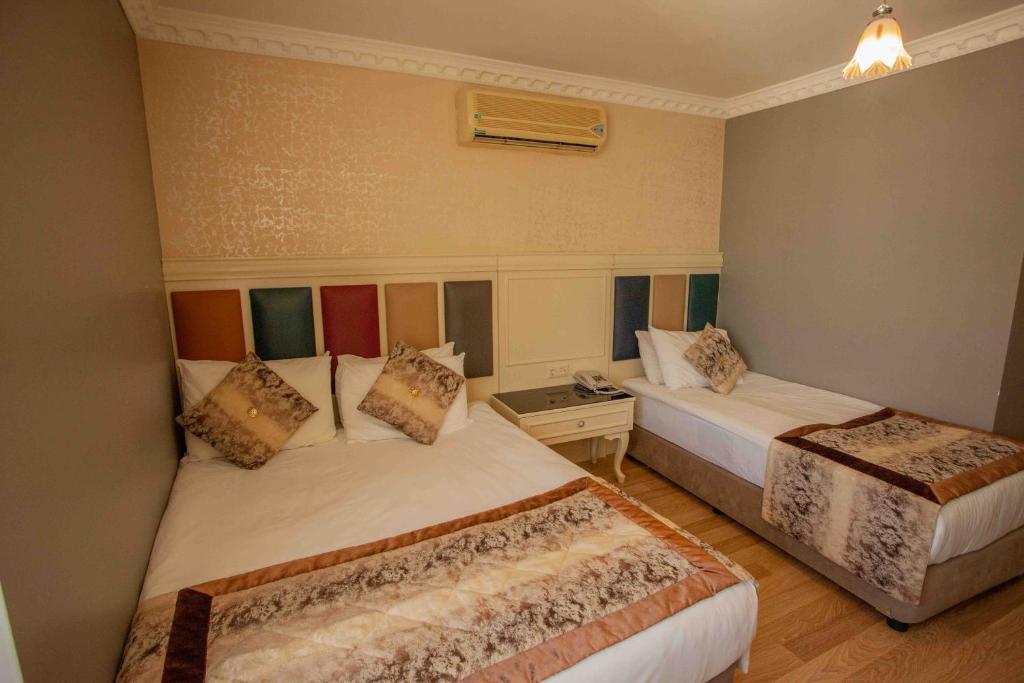 Postel nebo postele na pokoji v ubytování Best Nobel Hotel