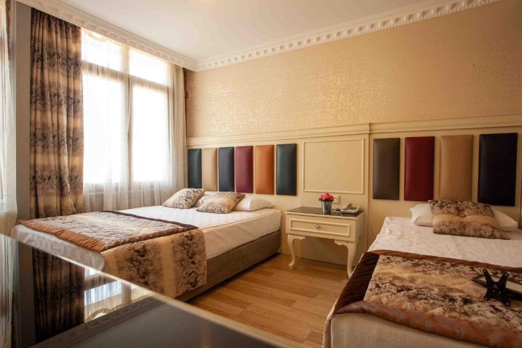 Postel nebo postele na pokoji v ubytování Best Nobel Hotel